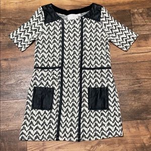 Tunic with faux leather details.